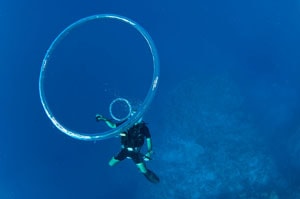 scuba diver blows bubble rings