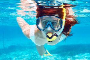 Woman with mask snorkeling