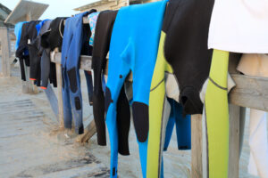 Neoprene costumes hanging on the wooden path