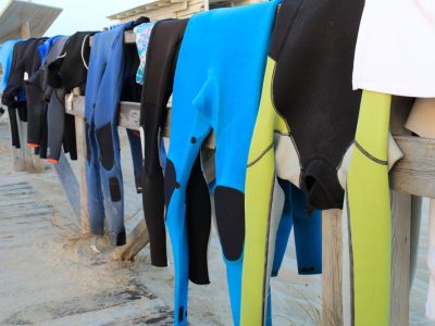 Neoprene costumes hanging on the wooden path